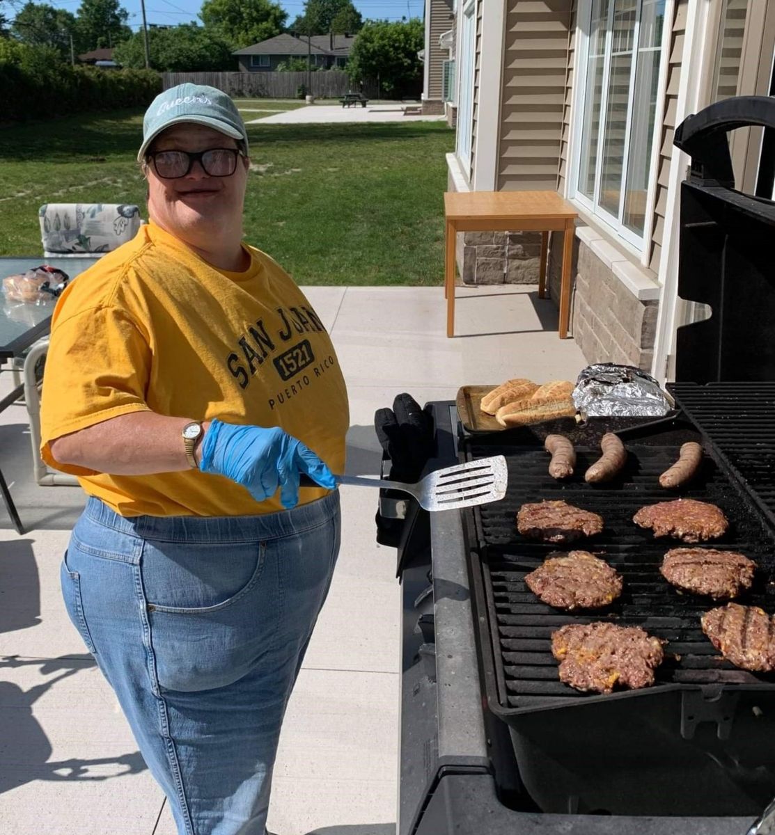 Ann is outside making dinner on the BBQ